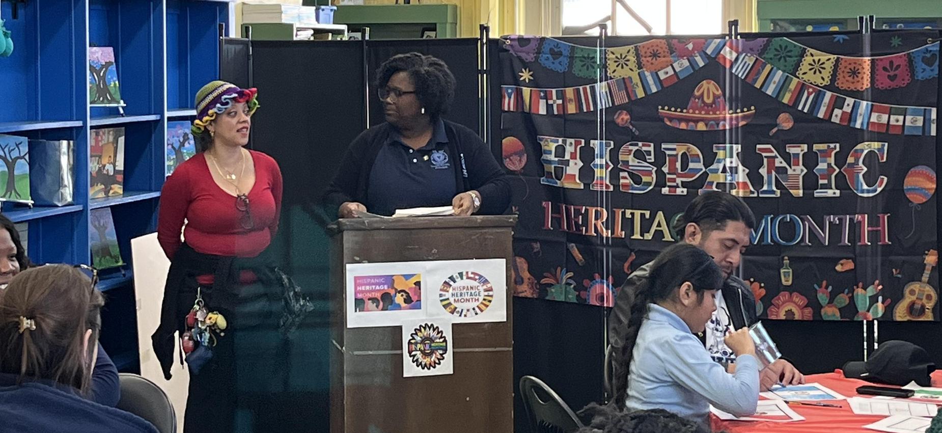 Two people talking at a podium