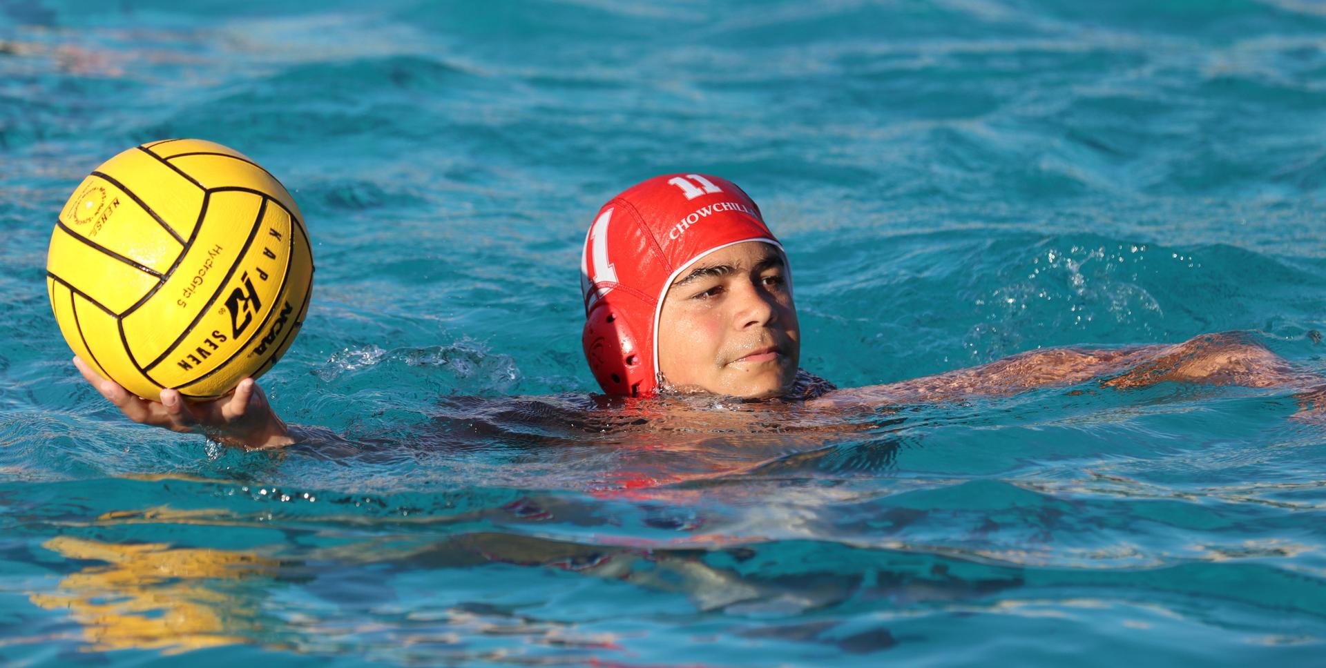 boys water polo players in action against hoover