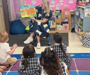 Teacher reading to little children