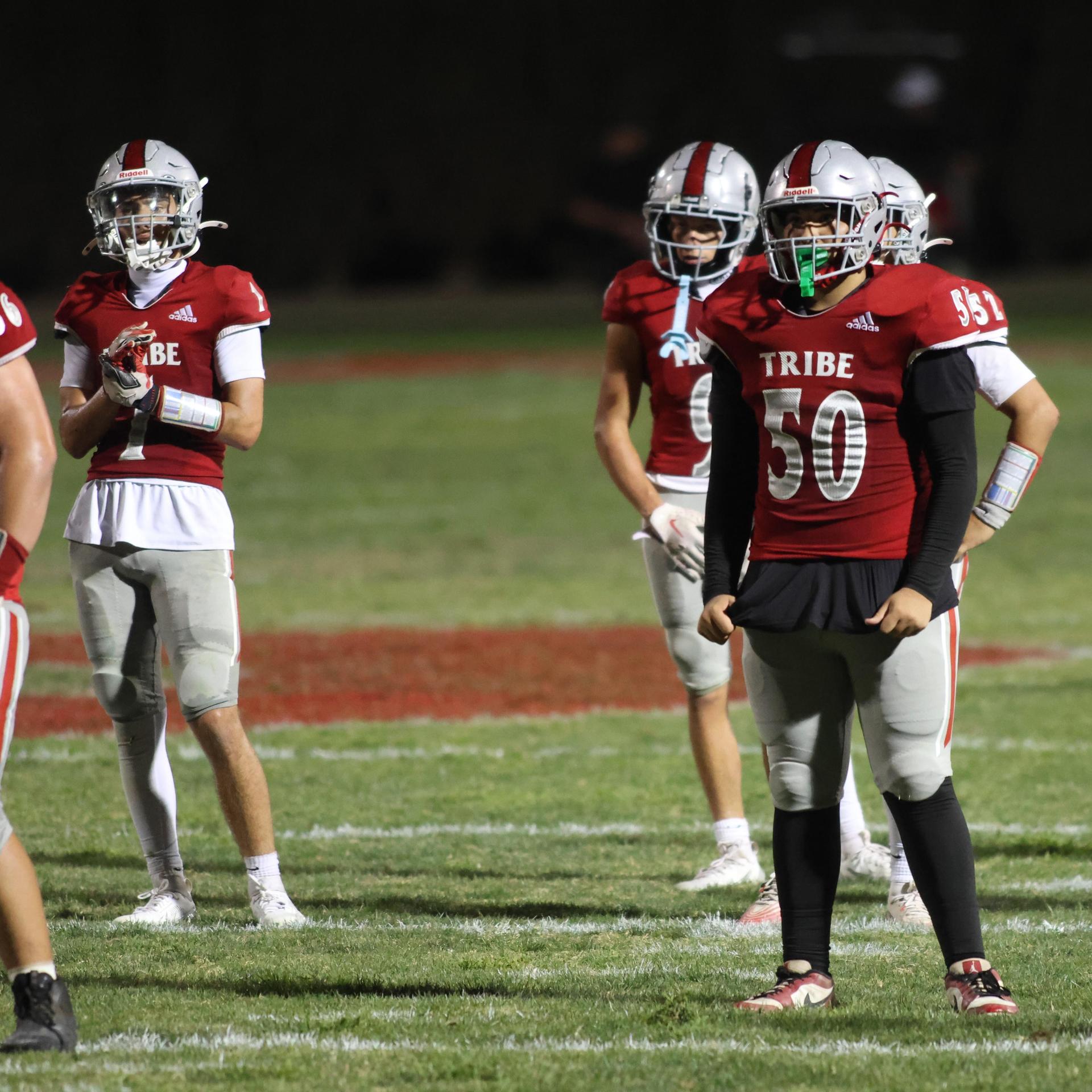 Varsity football players in action against Parlier 153