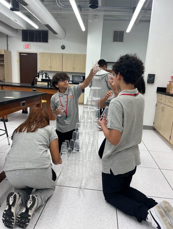students building towers with plastic cups