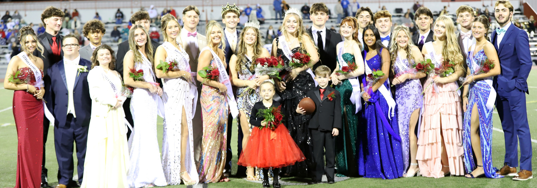 2026 Homecoming Court.  Students in formal attire posing together with flowers.