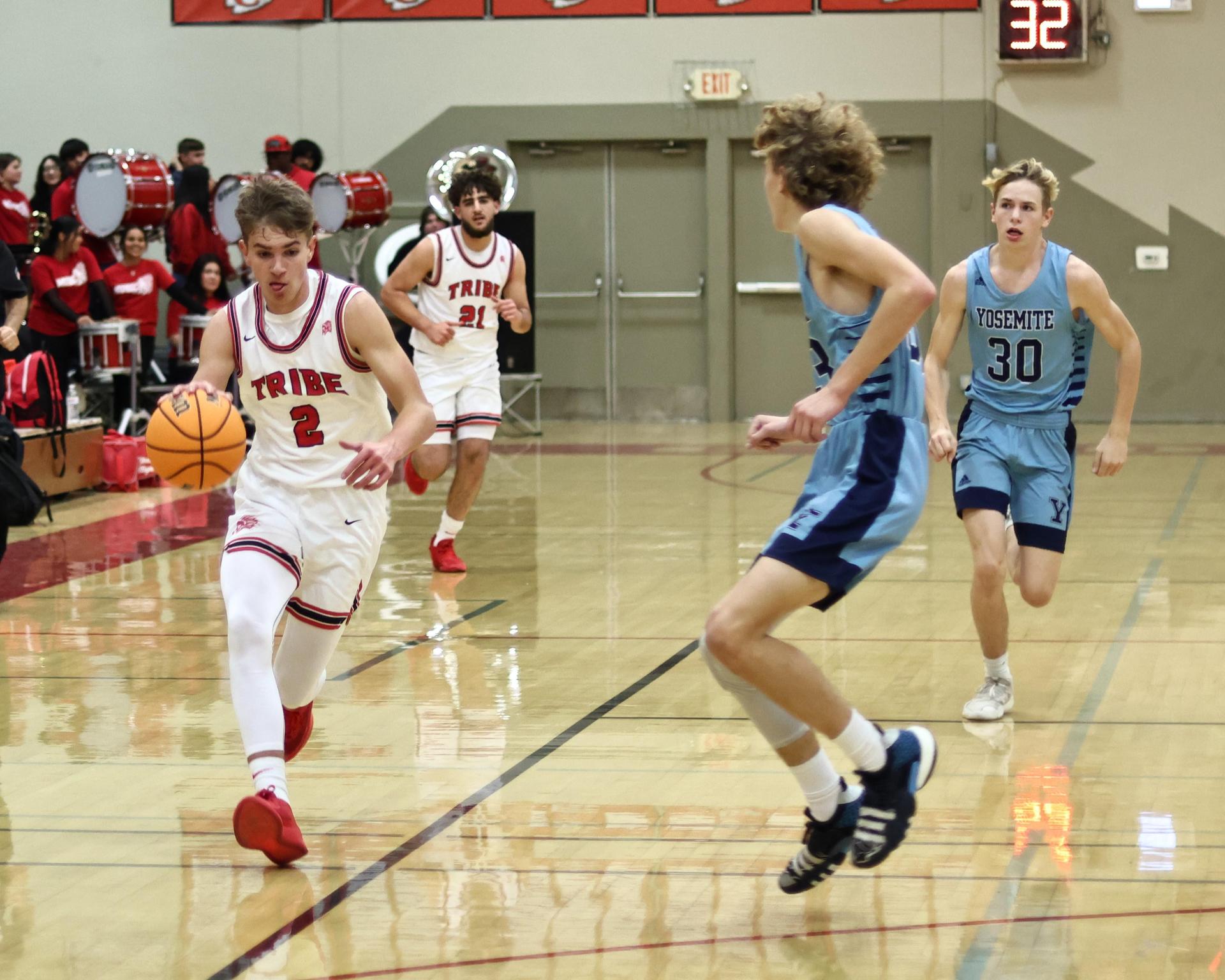 Varsity boys playing basketball against yosemite