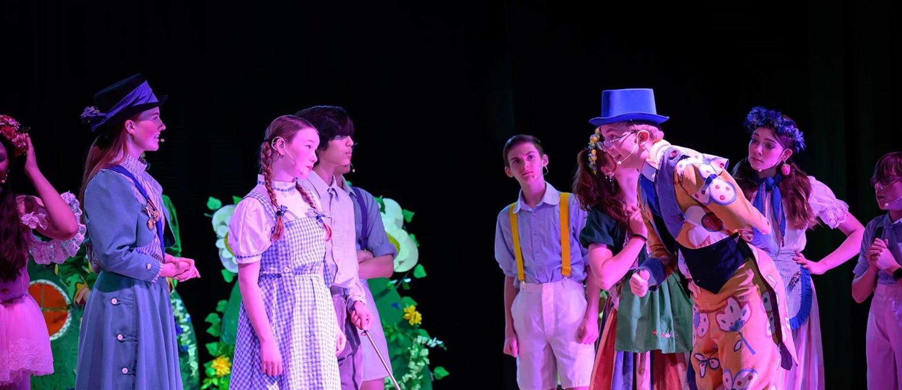 Students dressed as Dorothy, Toto, and Oz citizens