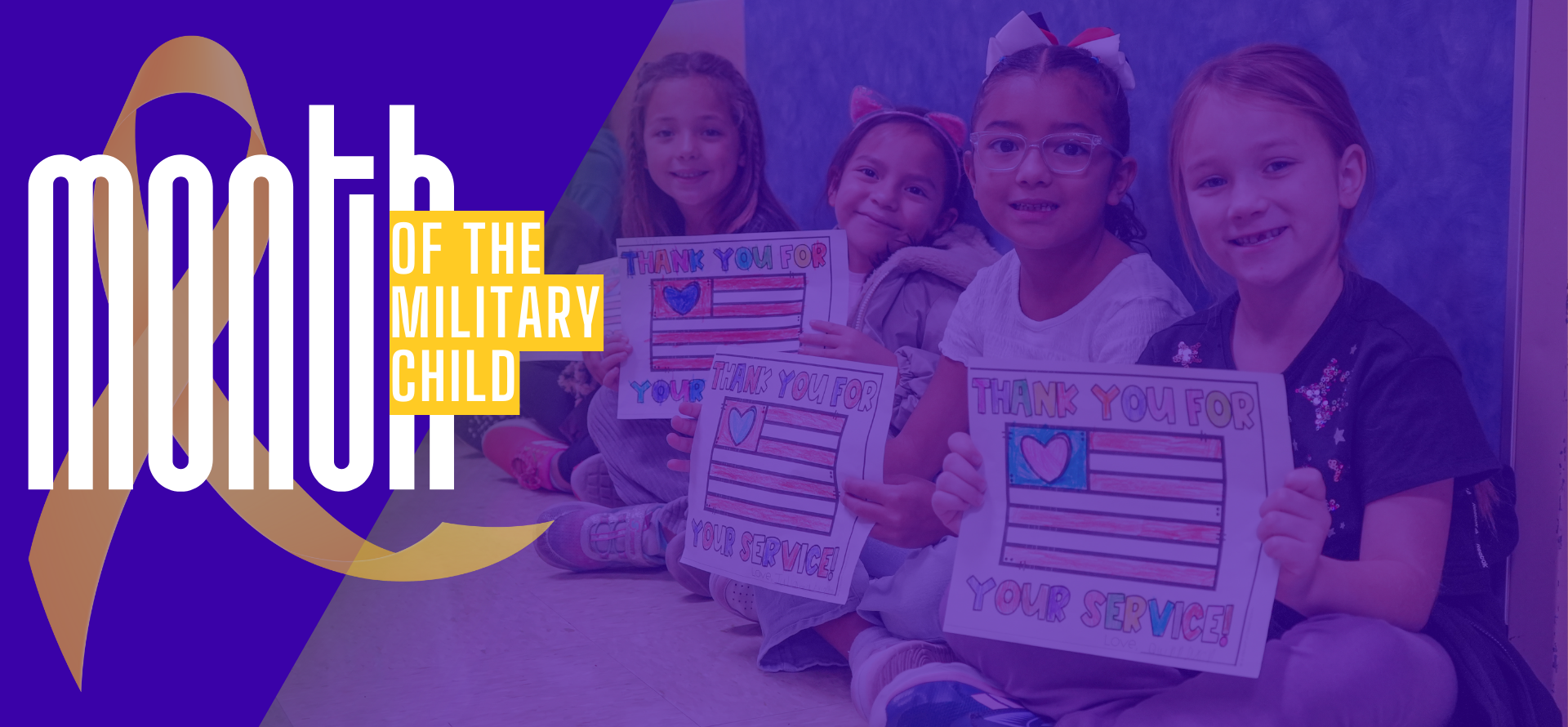 Kids sitting together holding colorful thank you posters for military service.