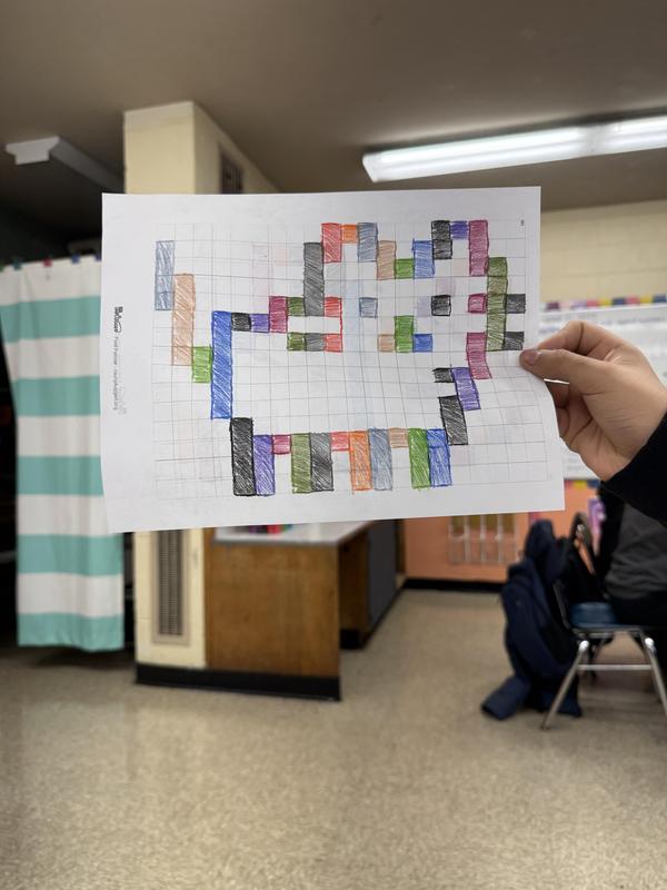 Students read binary codes to create a secret image