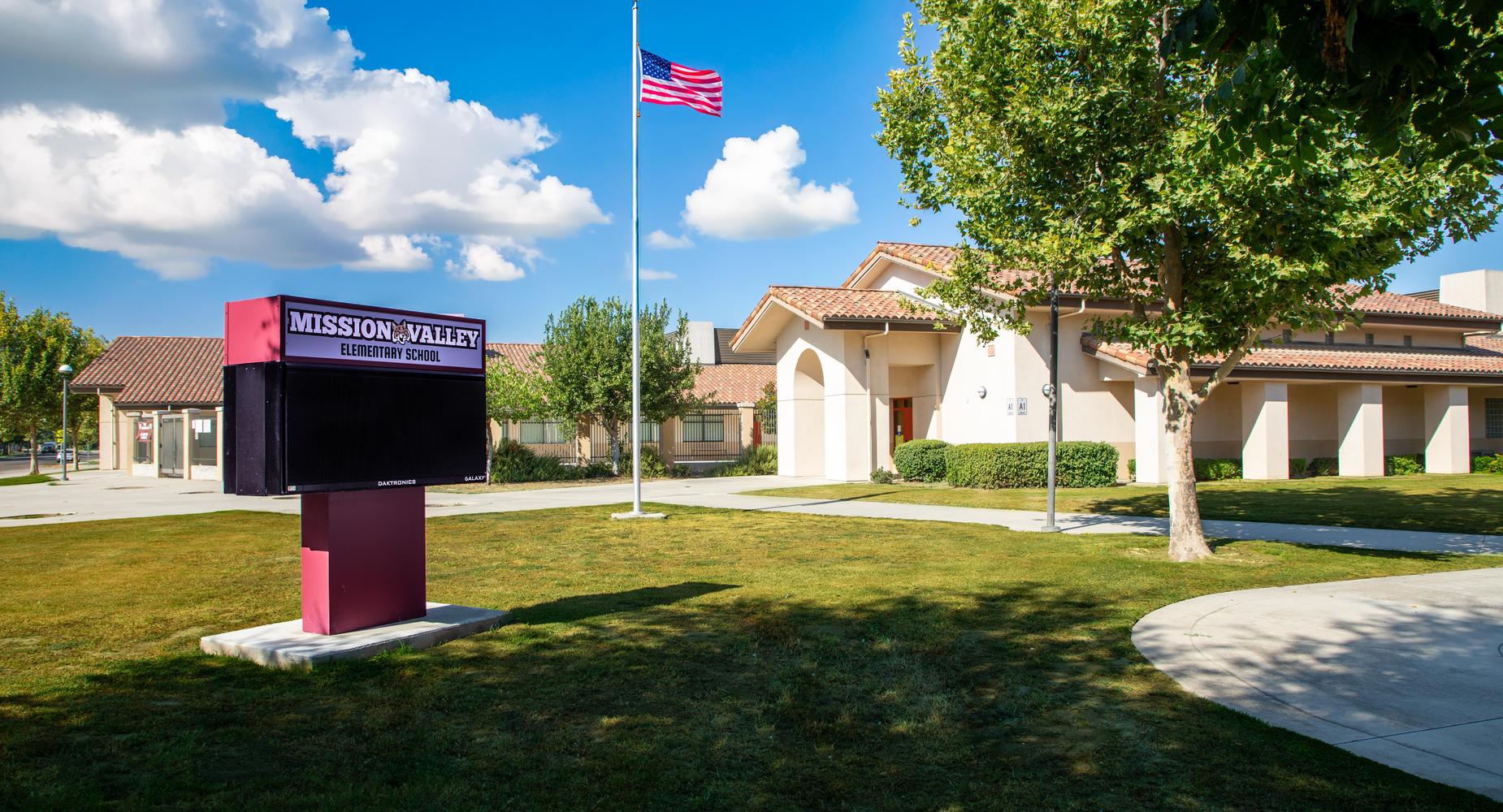 Exterior view of Mission Valley Elementary School with flag and marquee.