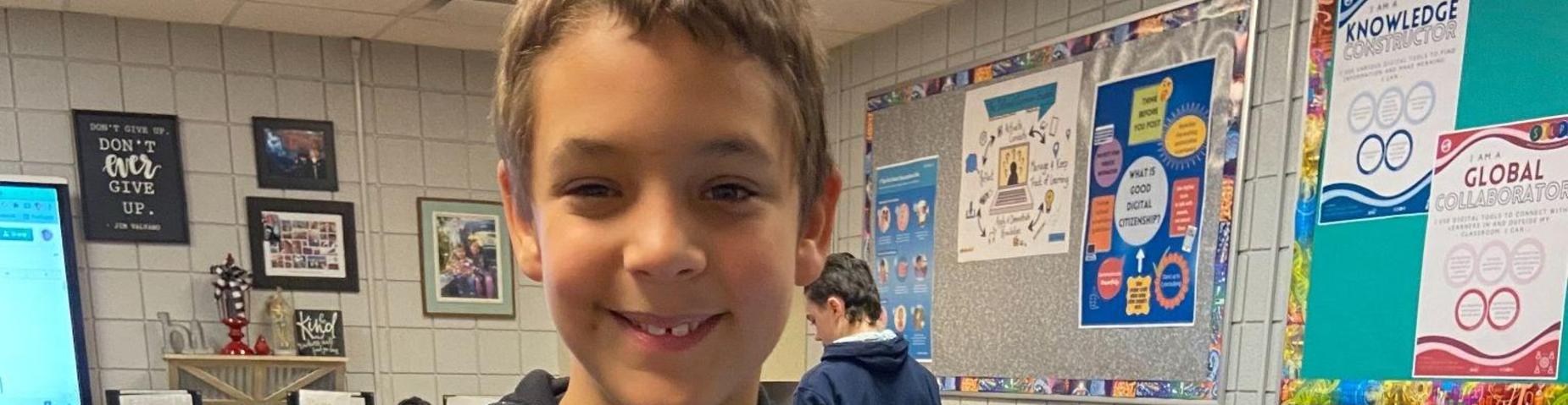 6th grader is having fun in technology class.