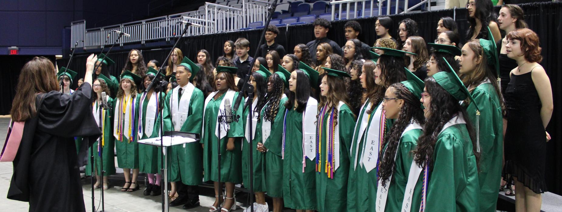 Choir Director Emily Johnson directs the CHSE choir at graduation.