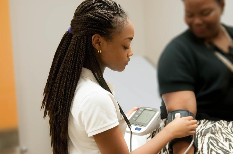 Student taking vitals of patient