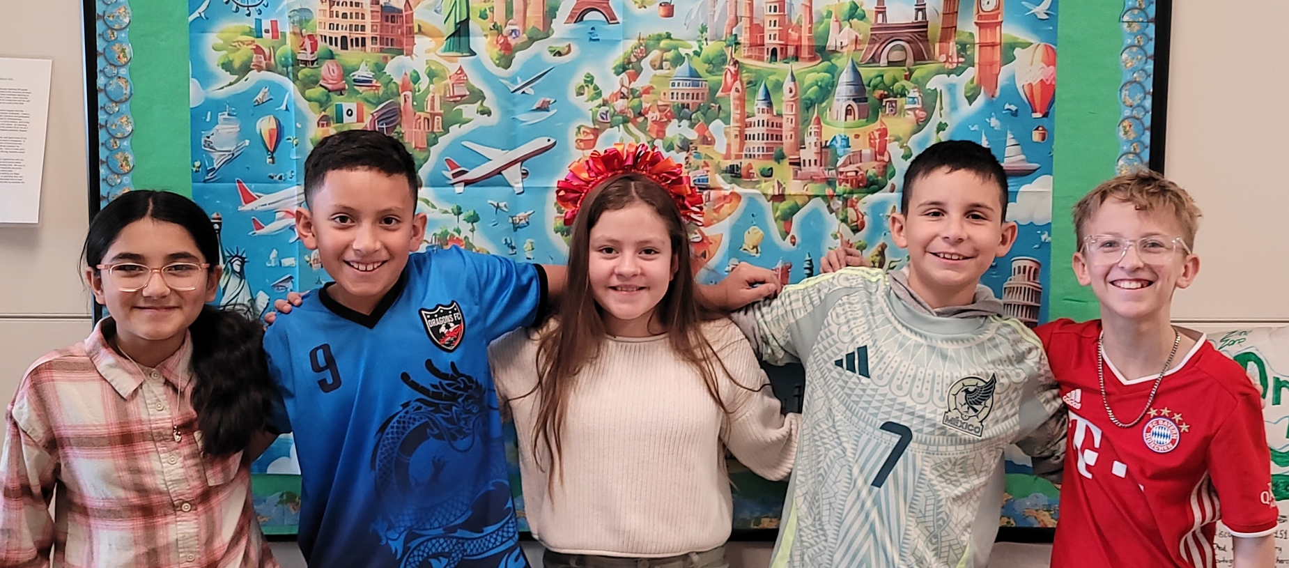 Five children stand together in front of a colorful mural featuring travel and landmarks.