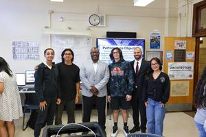 a photo of the principal and others in room 101