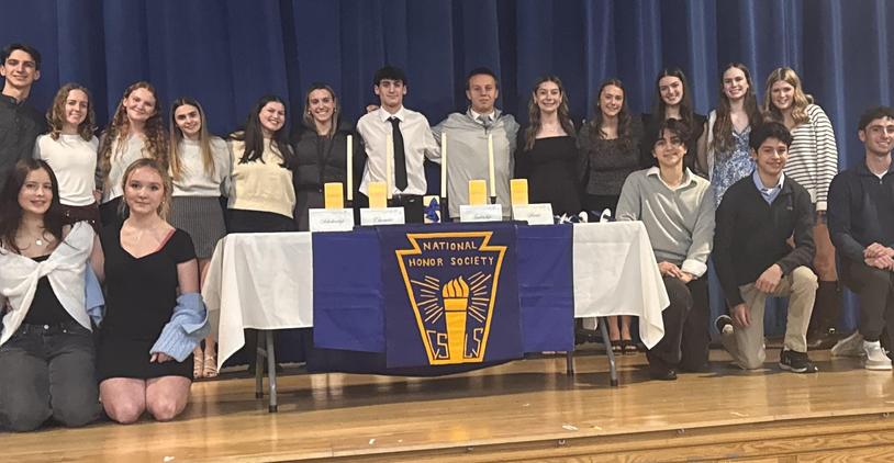 Group photo of students with awards at National Honor Society induction ceremony.