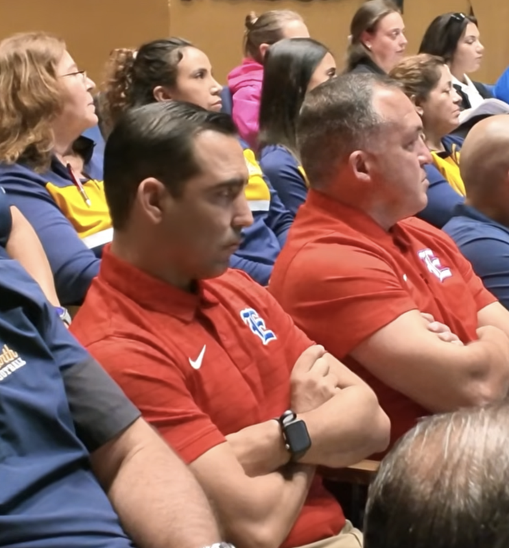 Coaches listening intently at an Athletics Department Meeting