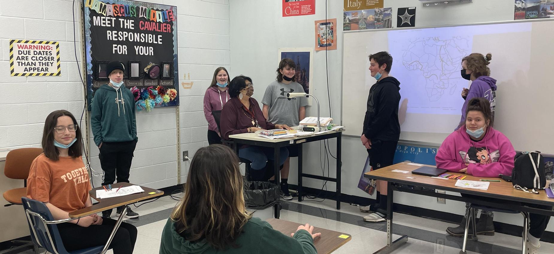 A teacher works with a group of students.