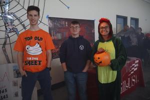 Students in costume pose for photo before handing out candy to kids