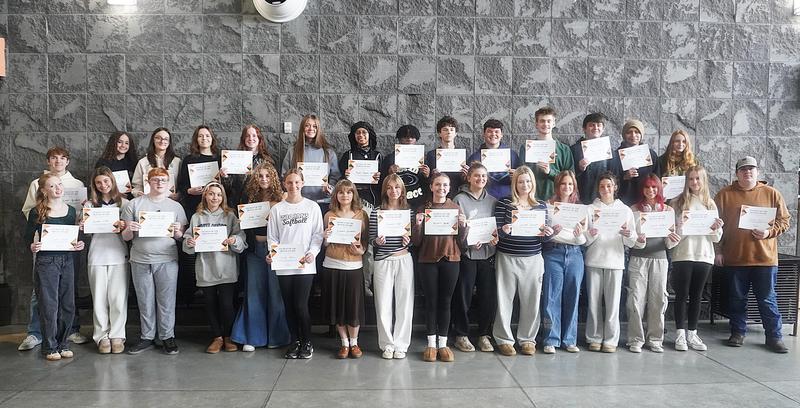 The TKHS November students of the month receive certificates.