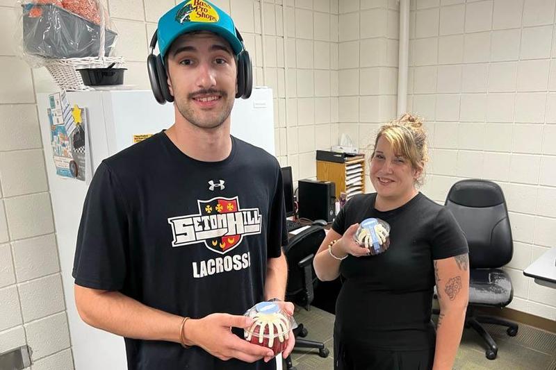 Penn-Trafford High School custodians Greg Mochan and Liz Zummo hold their bundt cake