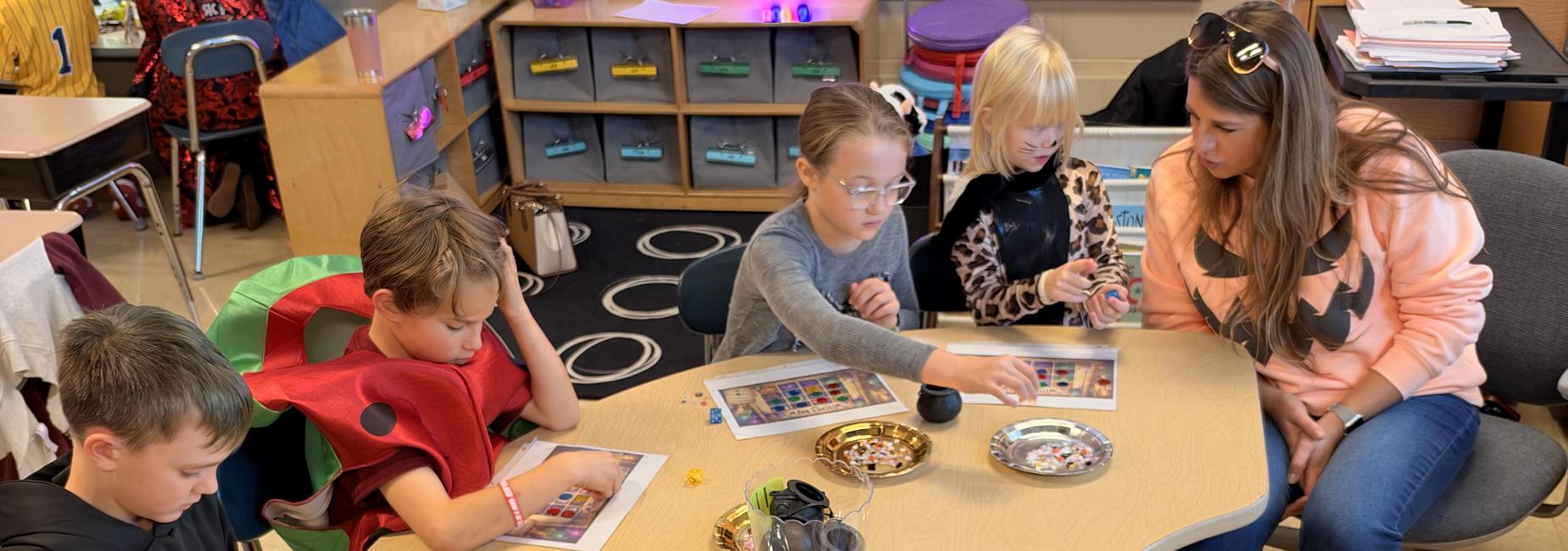 students sitting at a desk playing a game