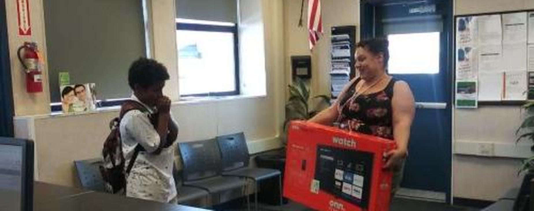 Atendance raffle winner surprised to learn that he won a new smart tv.