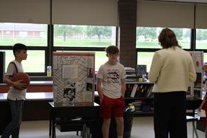 students dressed in character present information to principal