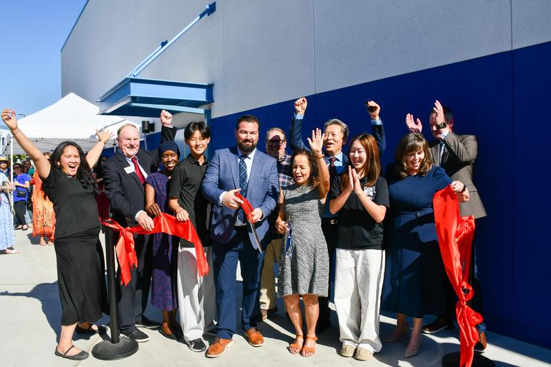 WVUSD Board of Trustees, Superintendent Dr. Taylor, Suzanne Principal Matt Spinogatti, Assistant Principal Dr. Nicolle Flores, Music Teachers Ami Garvin and Jeff Blackstone, and students Nicholas Yu and Ella Shih cut the ribbon in front of the new music building, celebrating its opening.