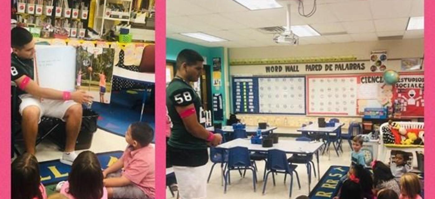 Alumni football player reading to a kinder class.