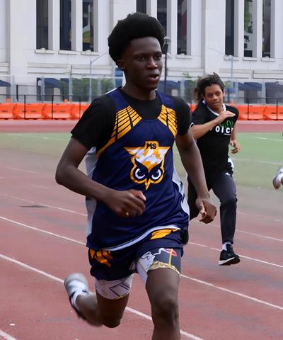 Student running at a track meet.