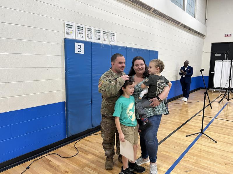Soldier and family reunite in the school gym