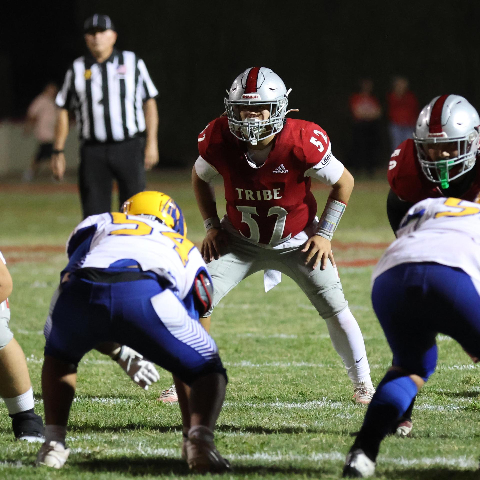 Varsity football players in action against Parlier 163