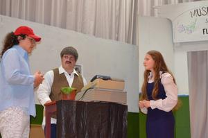 Three students on stage for the theater production.