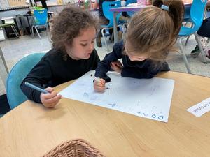 Two girls work together on their fire-safety poster