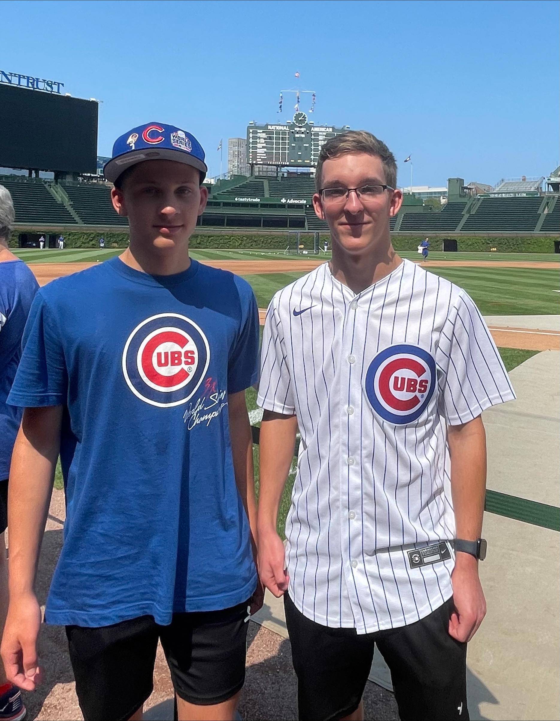 Two boys at a baseball park.