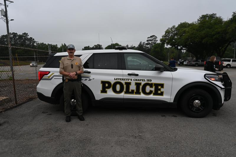 Mr. Guthrie outside the police car.