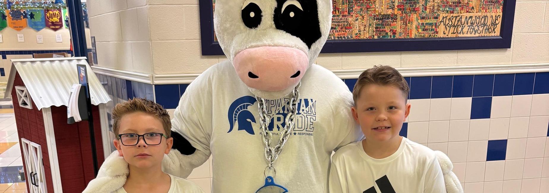 cow mascot with students