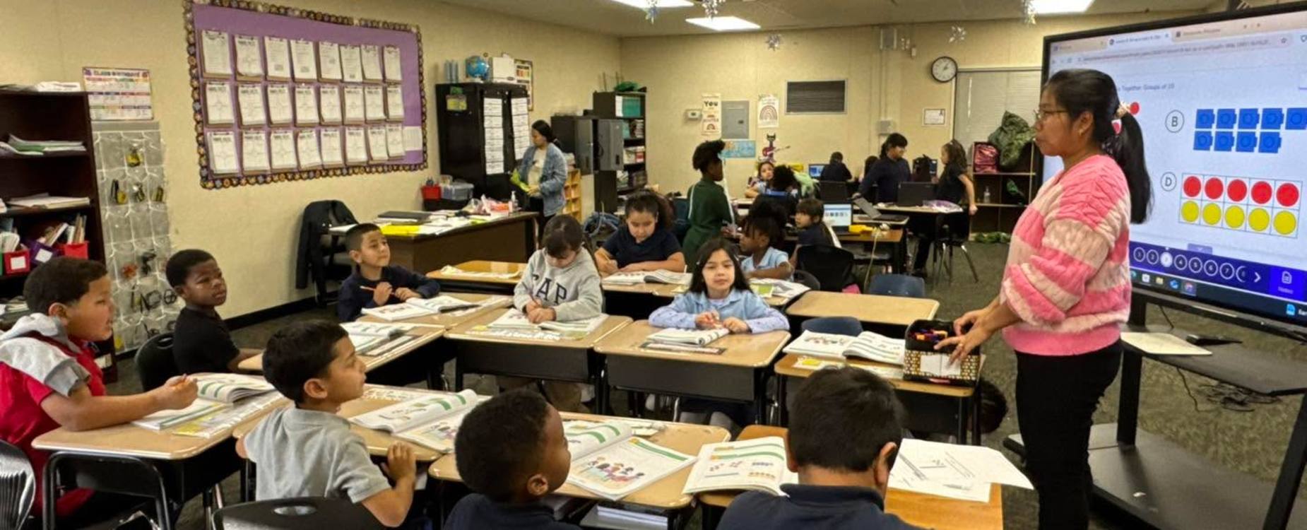 a group of students listening to their teacher