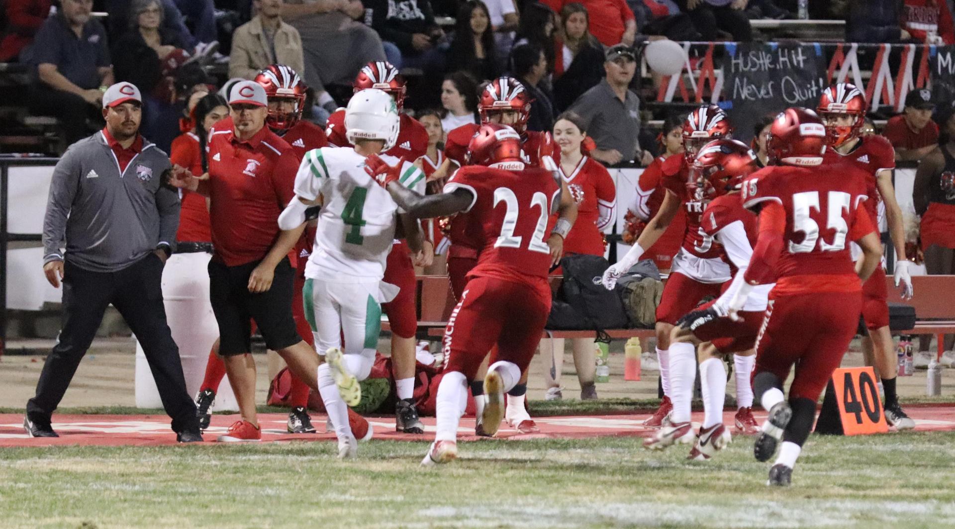 varsity football players in action against Riverdale
