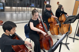 Orchestra students performing in a quartet