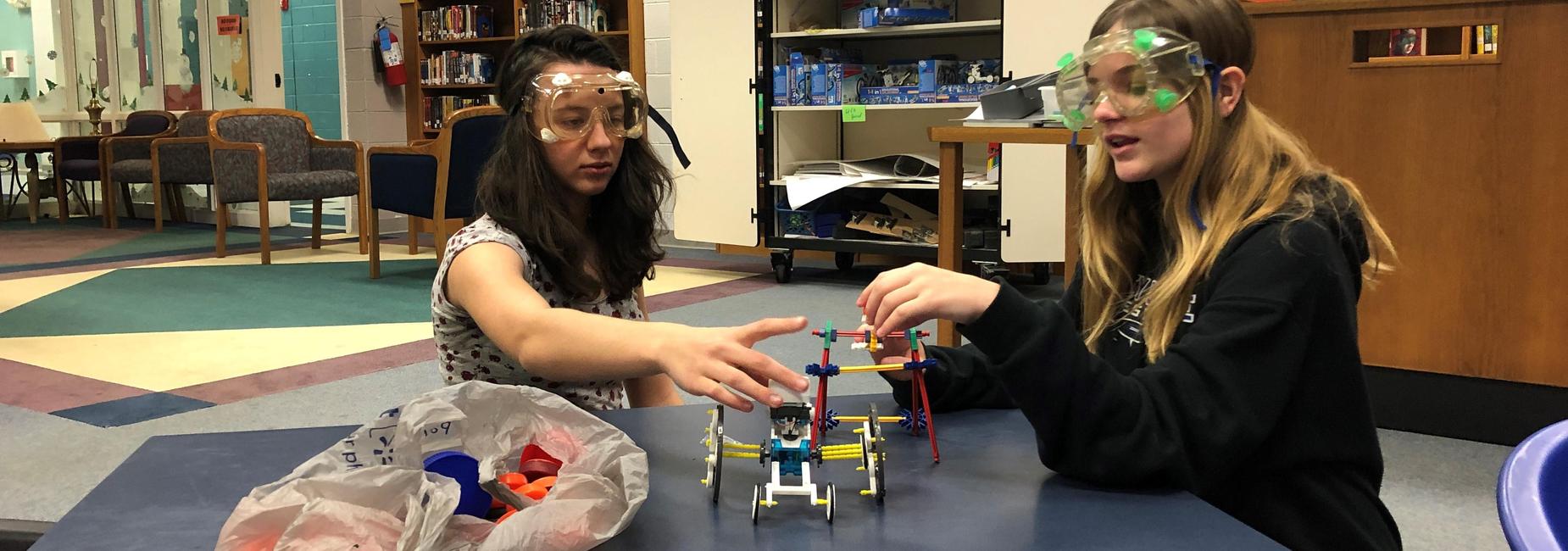 students in googles building with K'nex