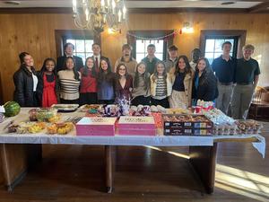Student Council members standing behind the breakfast food table.
