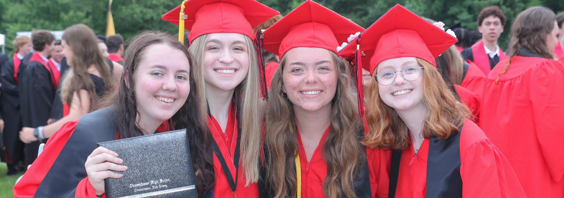 4 female graduates smiling with diploma