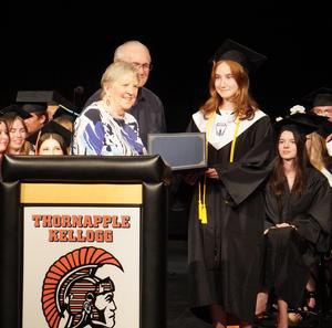 Don and Cathy Williamson present their scholarship to Lucy Teunessen.