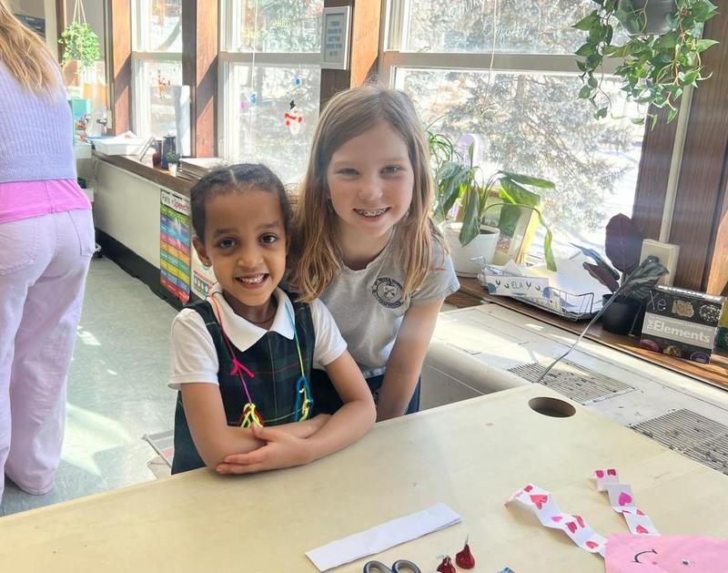 Picture of the week: two of our students celebrating St. Valentines day by making decorations with the help of some K2 parents!