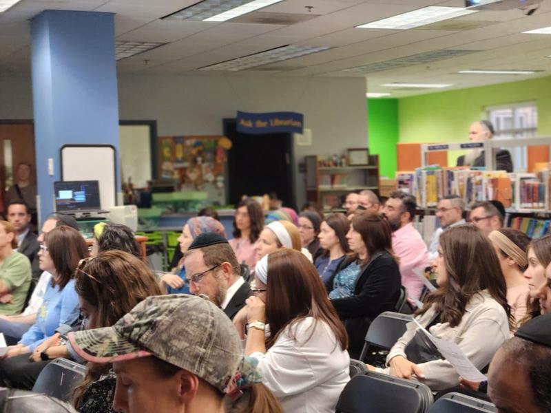 parents listening to opening remarks from Rabbi Cohen at Back to School Night