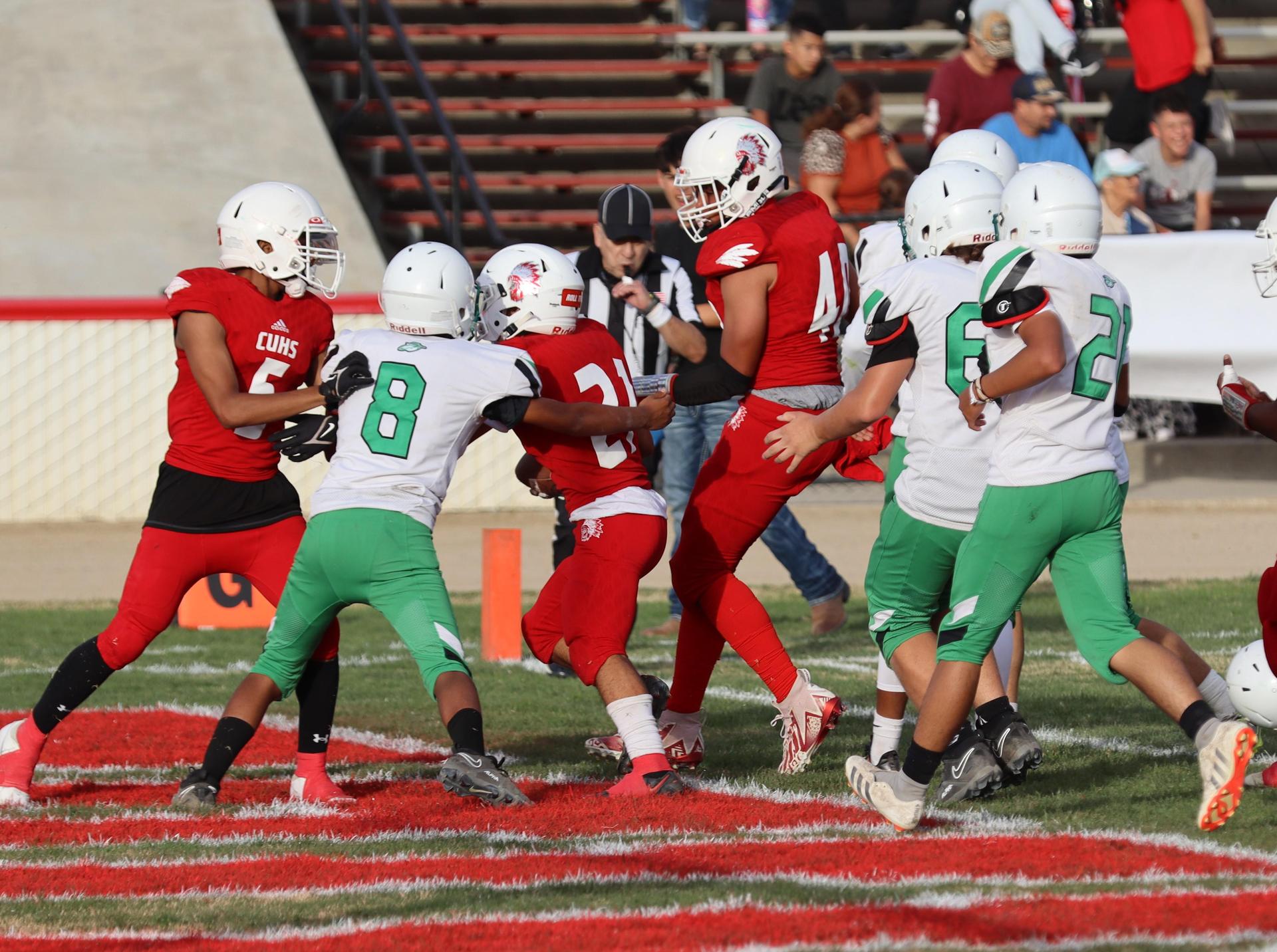  junior varsity football players in action against riverdale