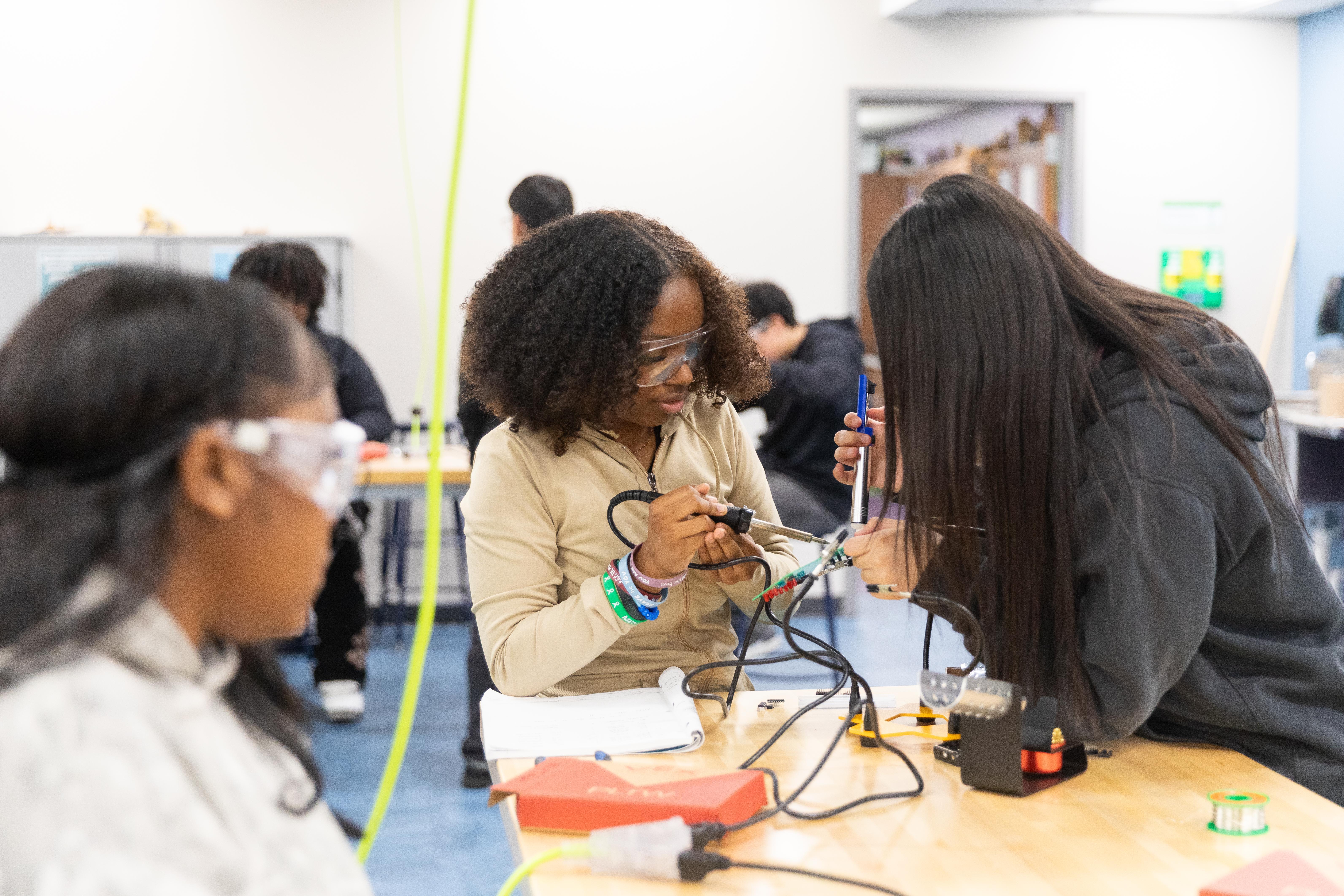 Three female students working on an engineering project in the Innovation Lab
