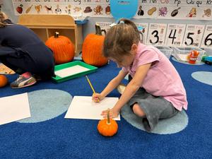 a student practices drawing a pumpkin