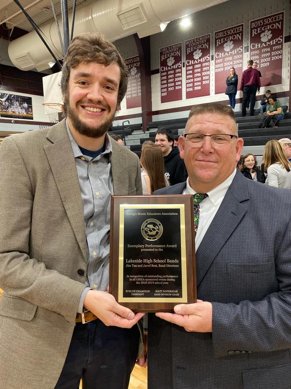 Holding plaque and smiling