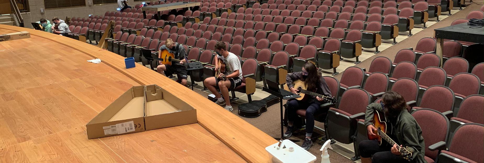 social distancing in the auditorium to learn guitar