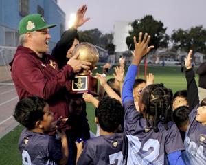 Students celebrate with trophy
